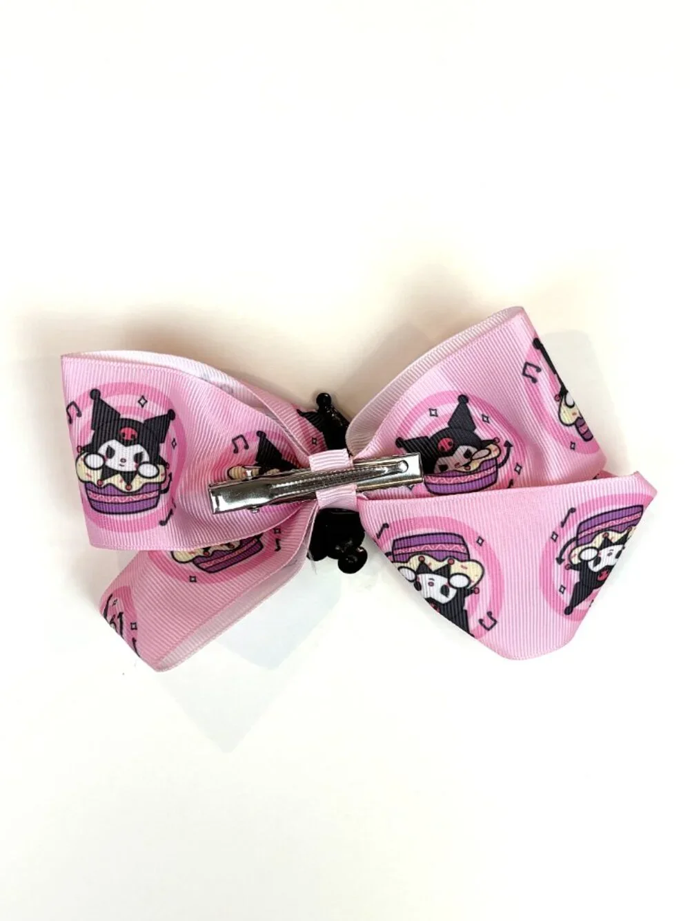 Cute pink Sanrio hair bow featuring Kuromi and an all-over Kuromi pattern. New